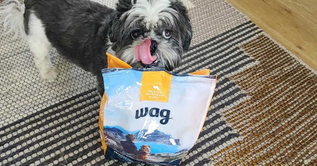 dog standing behind bag of wag dog food
