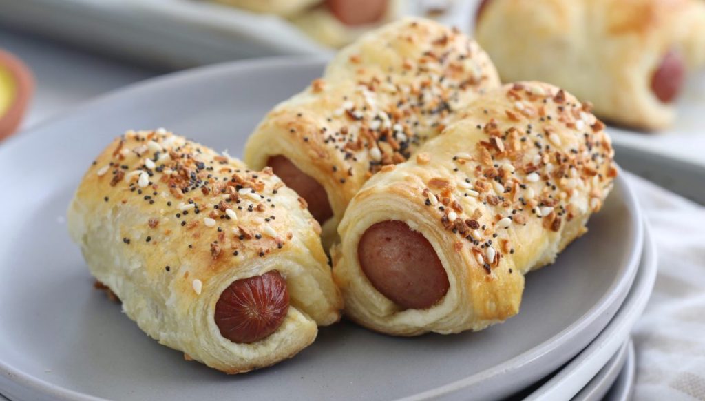 a plate of pigs in a blanket puff pastry appetizers