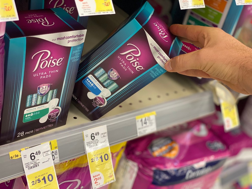 hand pulling off Poise Ultra Thin Pads from shelf