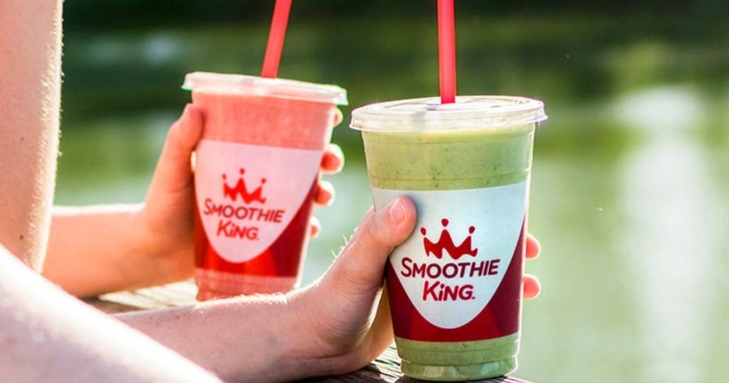 two hands holding smoothies