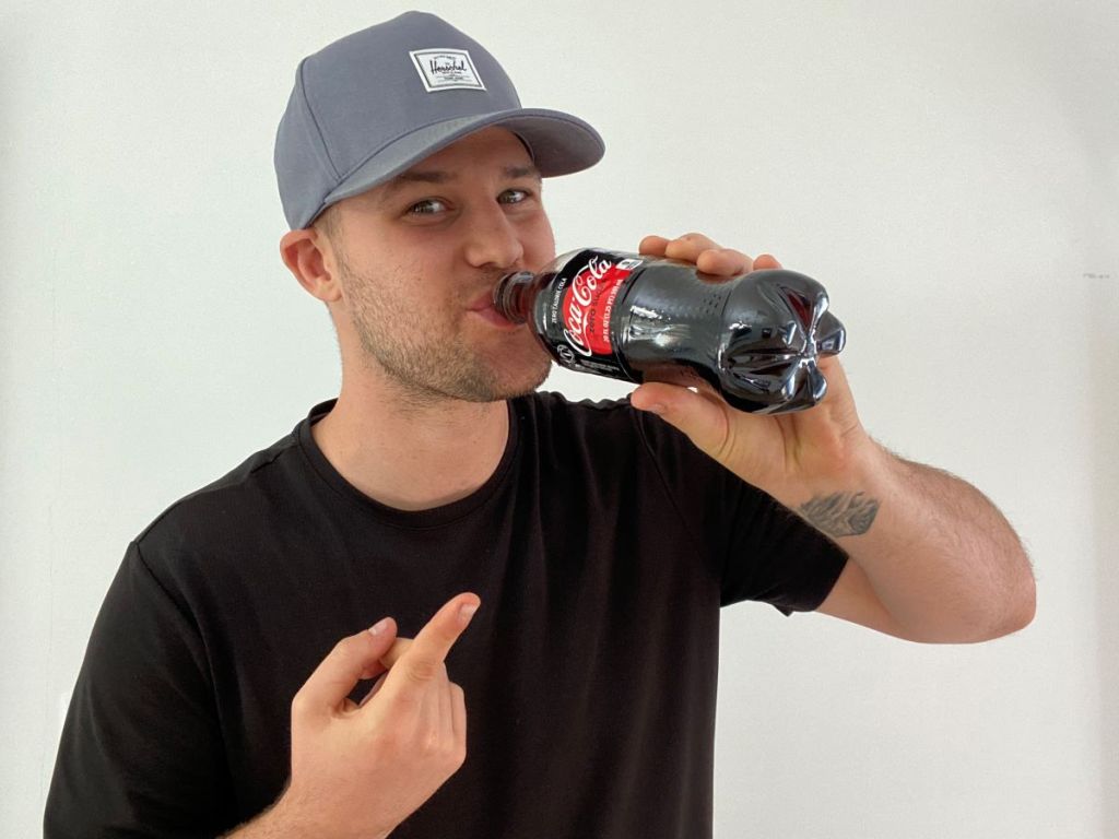 man drinking a Coke