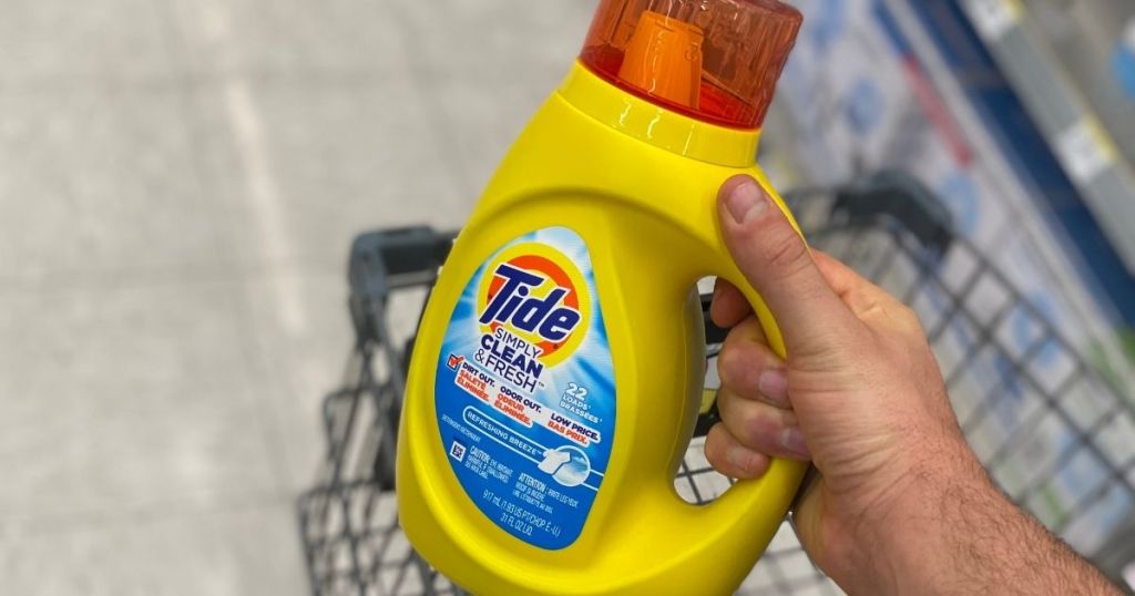 hand holding a bottle of Tide