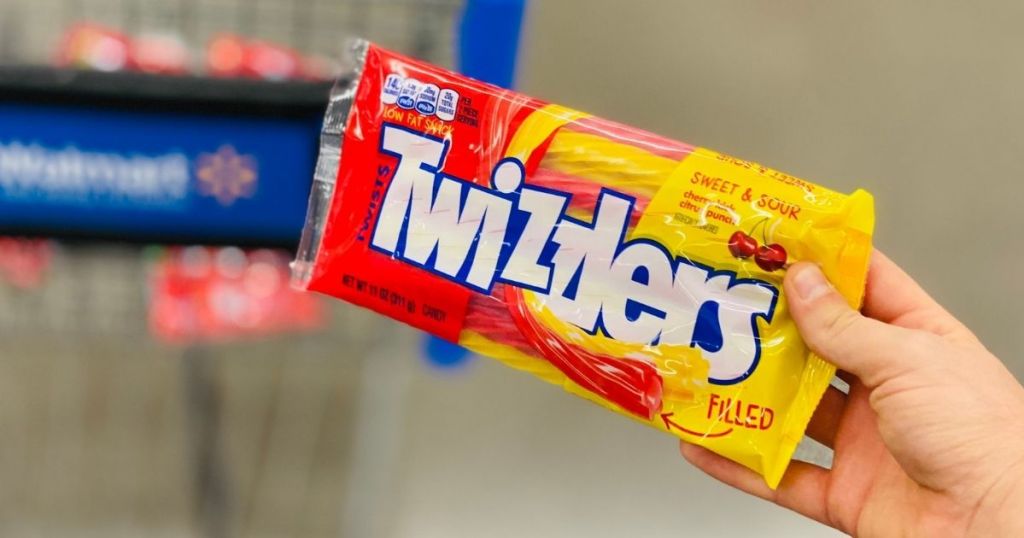 hand holding Twizzlers filled sweet and sour bag