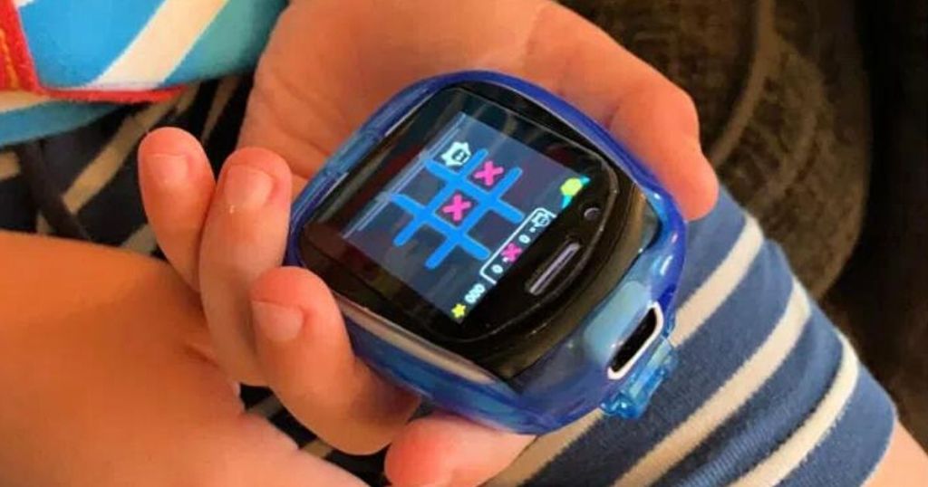 hands holding Little Tikes Tobi Robot Smartwatch Blue playing tic tac toe