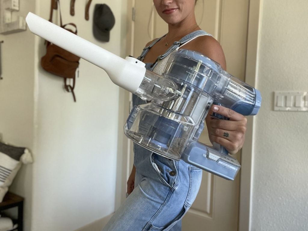 woman holding handheld vacuum