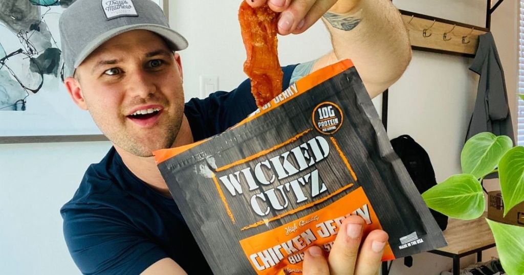 Man opening bag of Wicked Cutz premium jerky