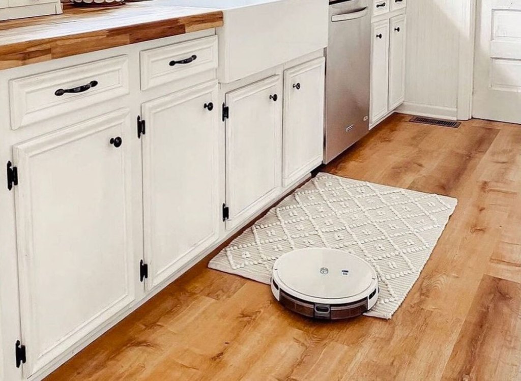 white robot vacuum in kitchen