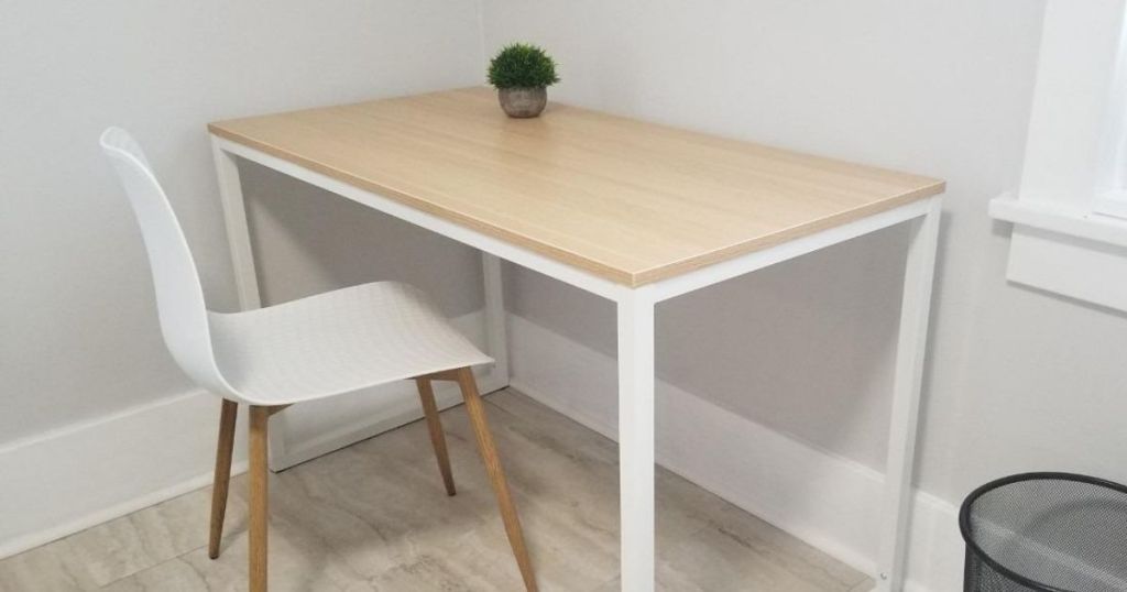desk with a white chair and a small plant on it