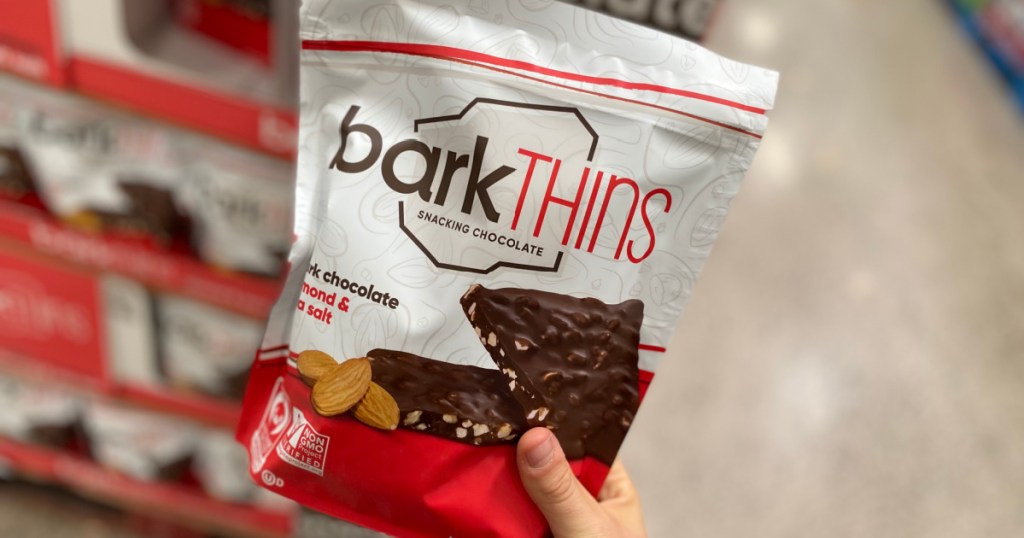 hand holding bag of snacking chocolate in store