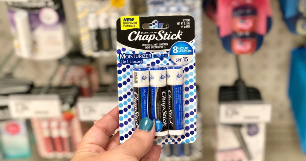 hand holding up blue pack of chapstick