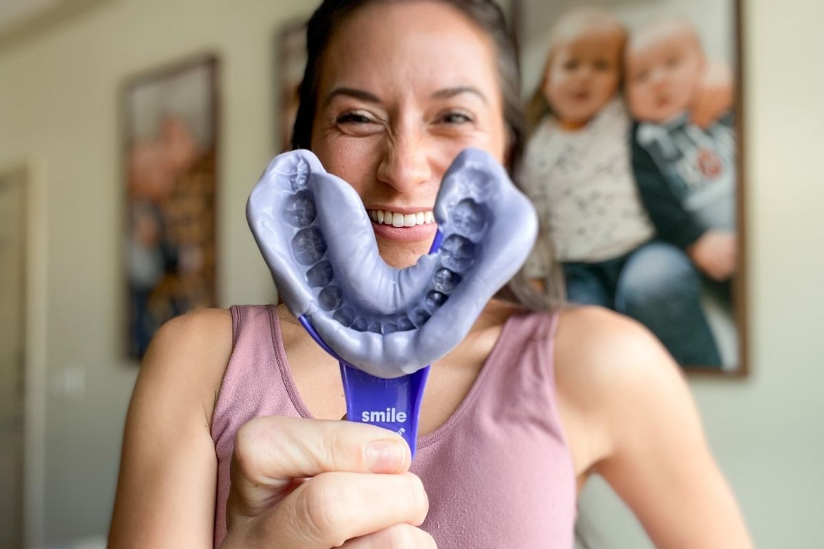 woman holding Smile Direct Club teeth impression tray