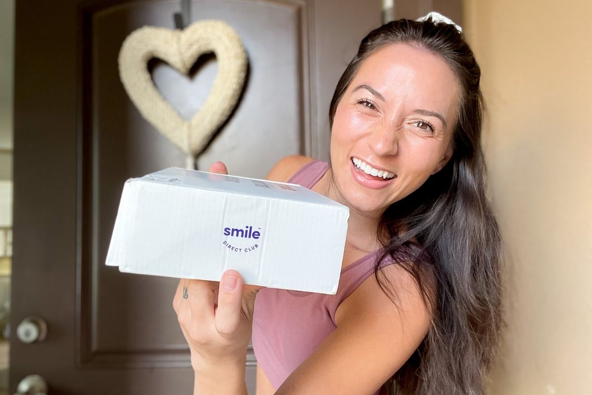 woman holding a box from Smile Direct Club