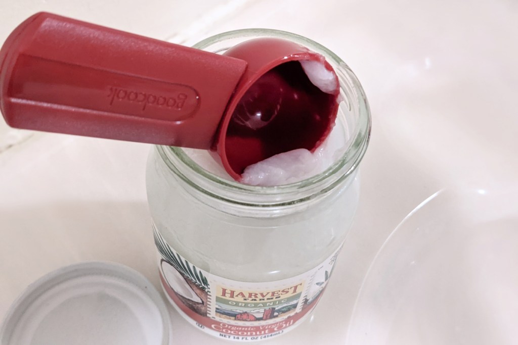 spoon sticking out of coconut oil jar