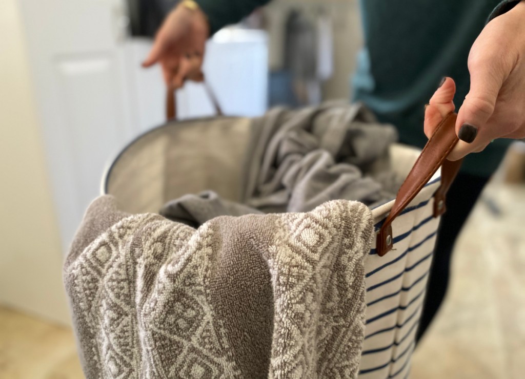 woman holding a collapsible laundry basket