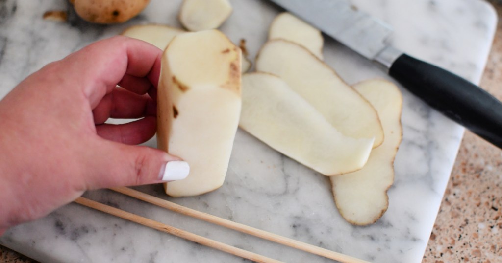 cutting a potato for hasselback potato bites 