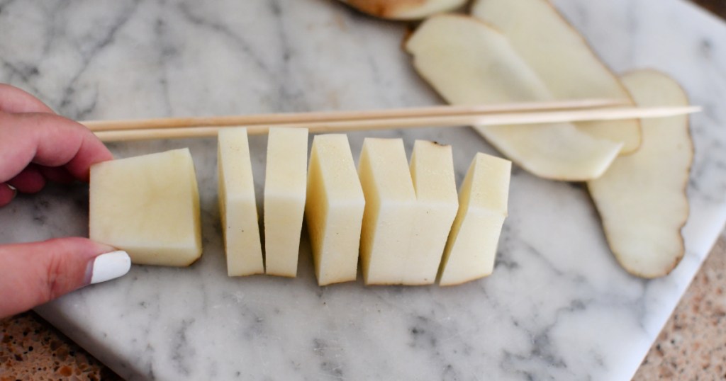 cutting potatoes into square bites