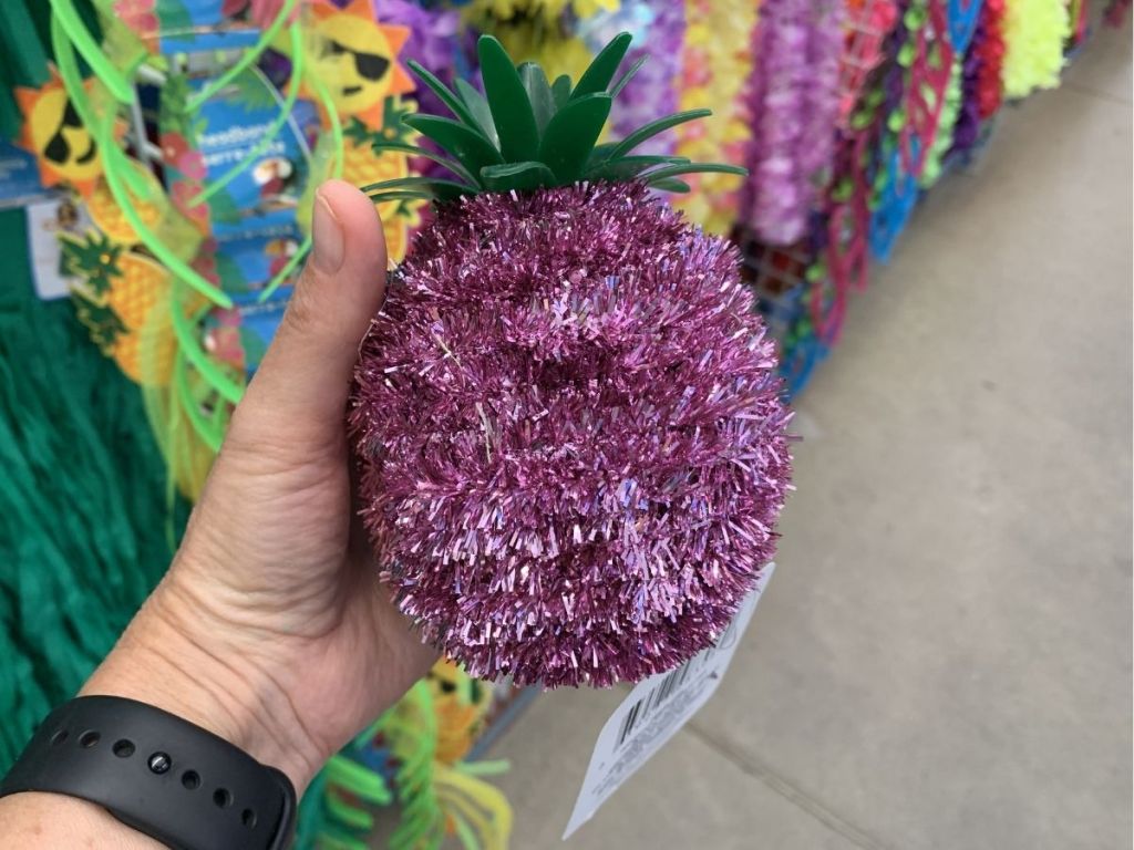 hand holding pink tinsel pineapple