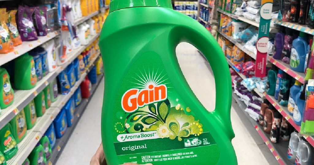 hand holding bottle of gain laundry detergent in store
