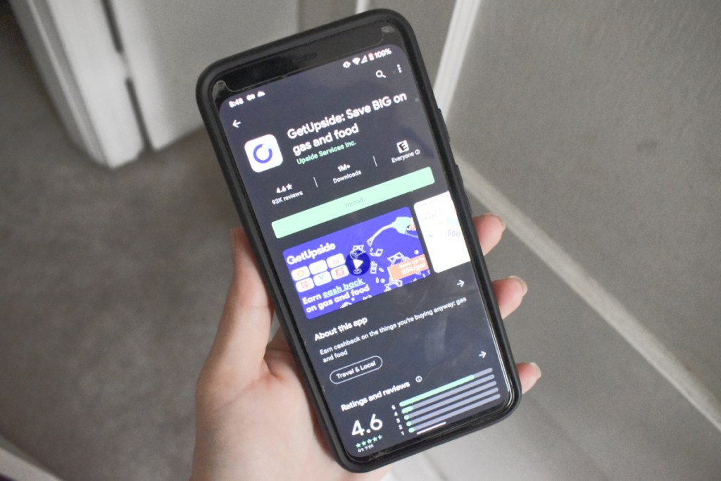 hand holding phone with Google Play store downloading GetUpside app
