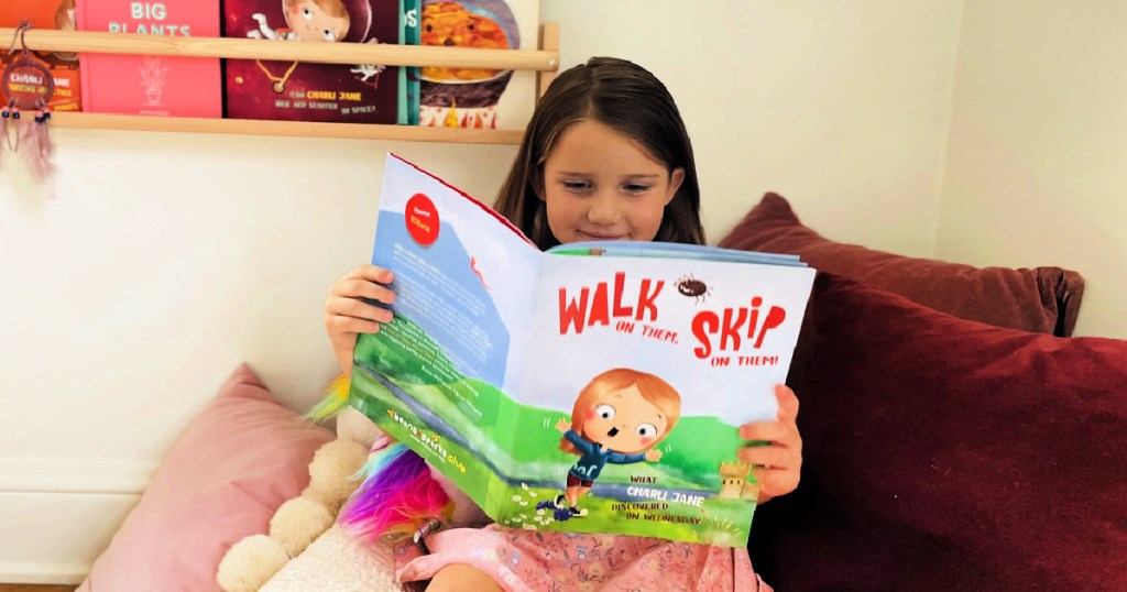 girl holding walk and skip book