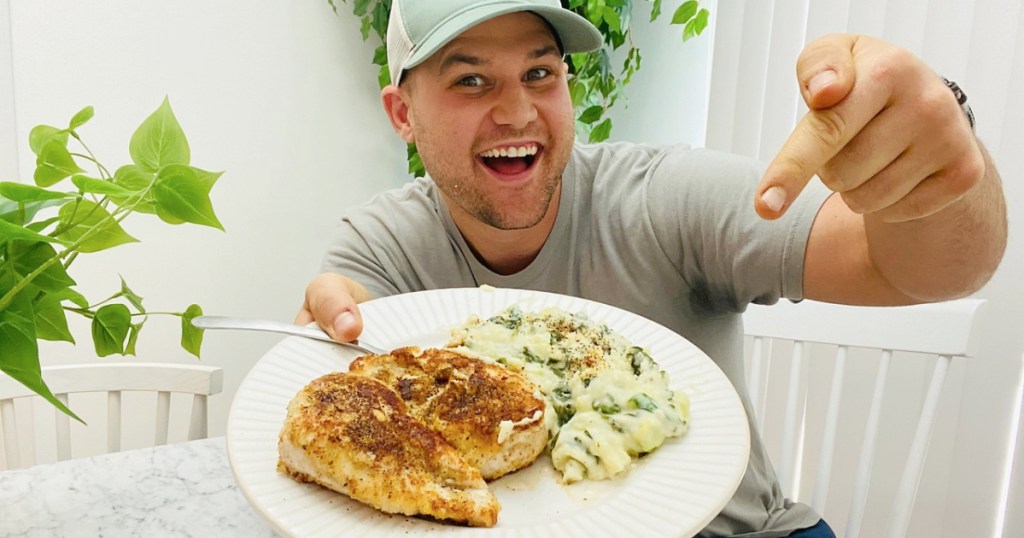 man showing off a plate of food