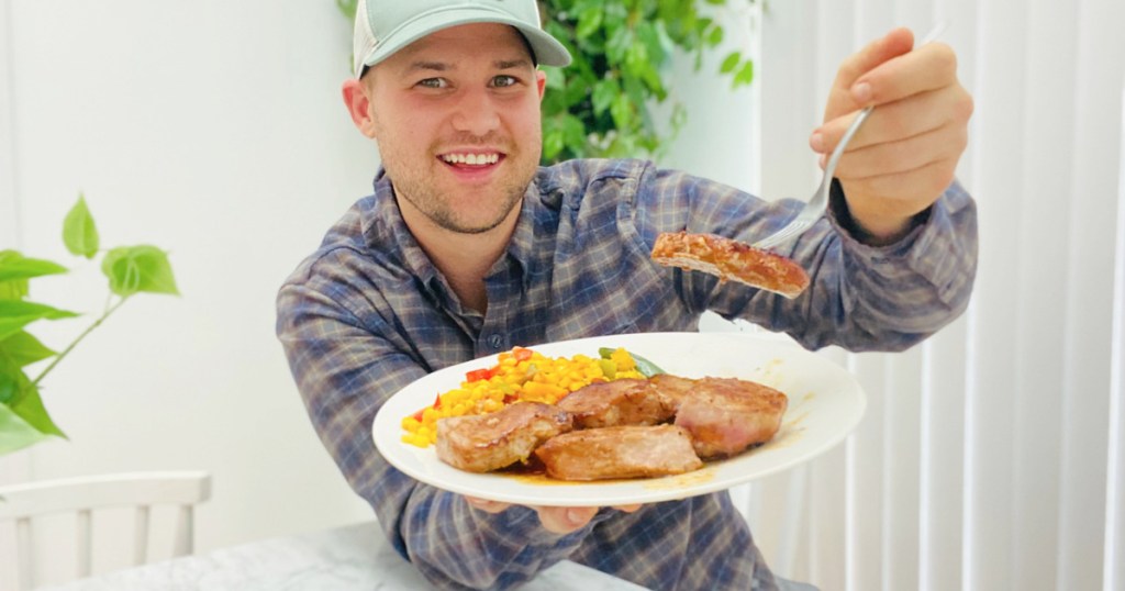 man holding up a plate of food