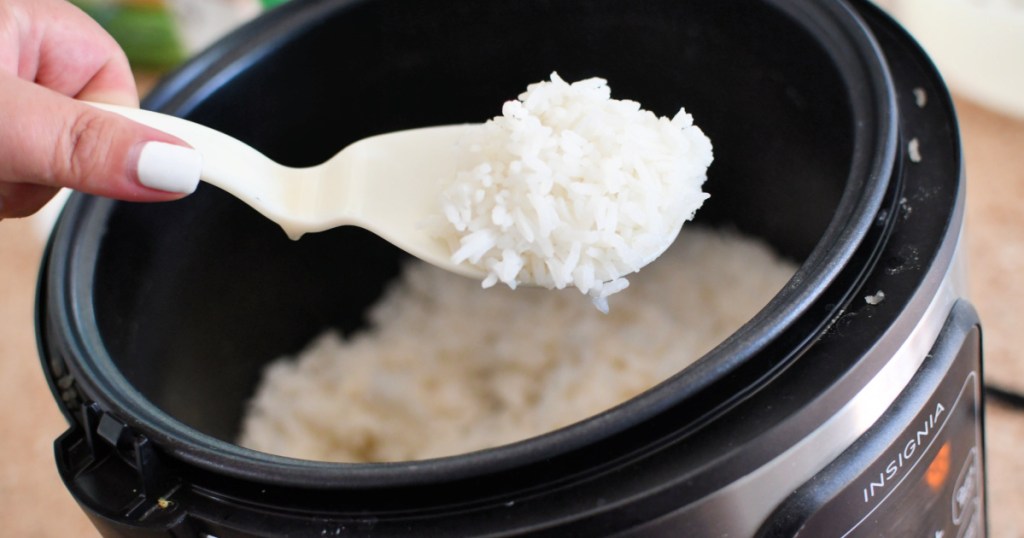 scooping white rice out of rice cooker