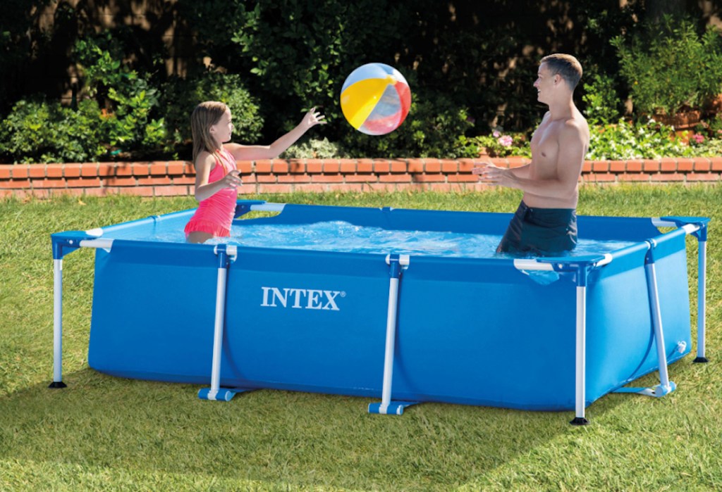 two kids playing with beach ball in pool