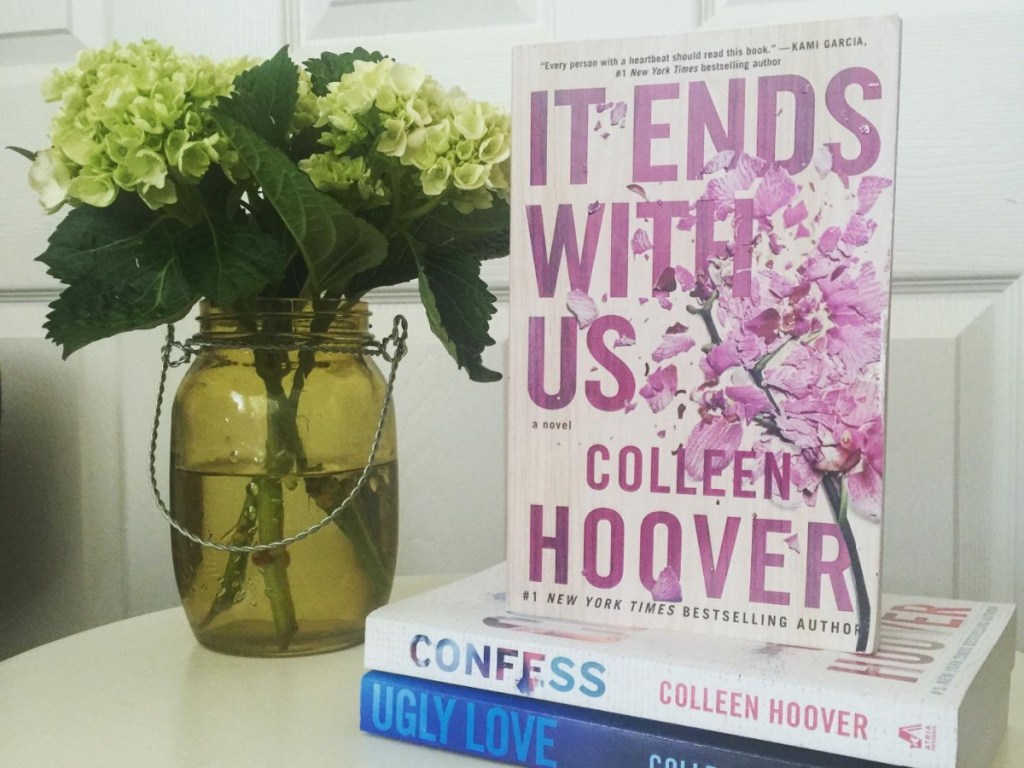 Colleen Hoover books next to flower vase