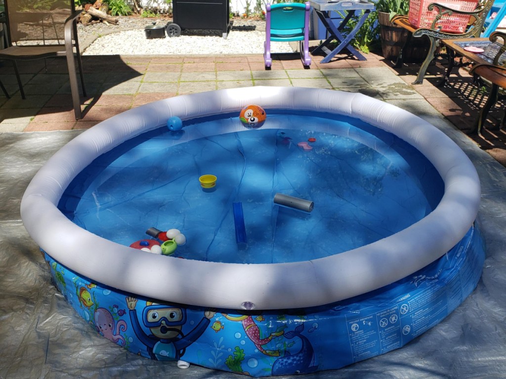 colorful inflatable pool with water toys in it