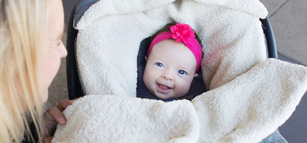 baby girl wearing pink headband smiling