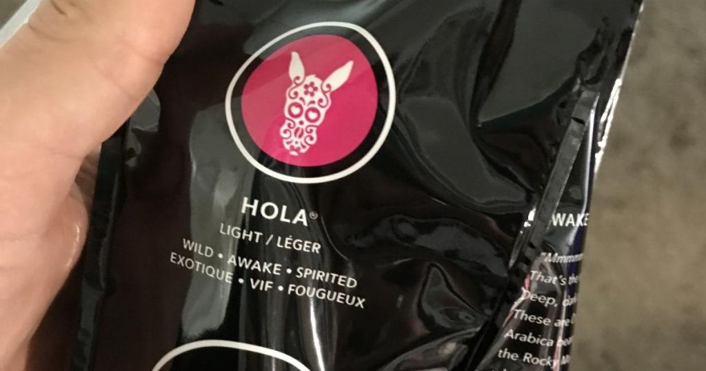 hand holding bag of Hola coffee