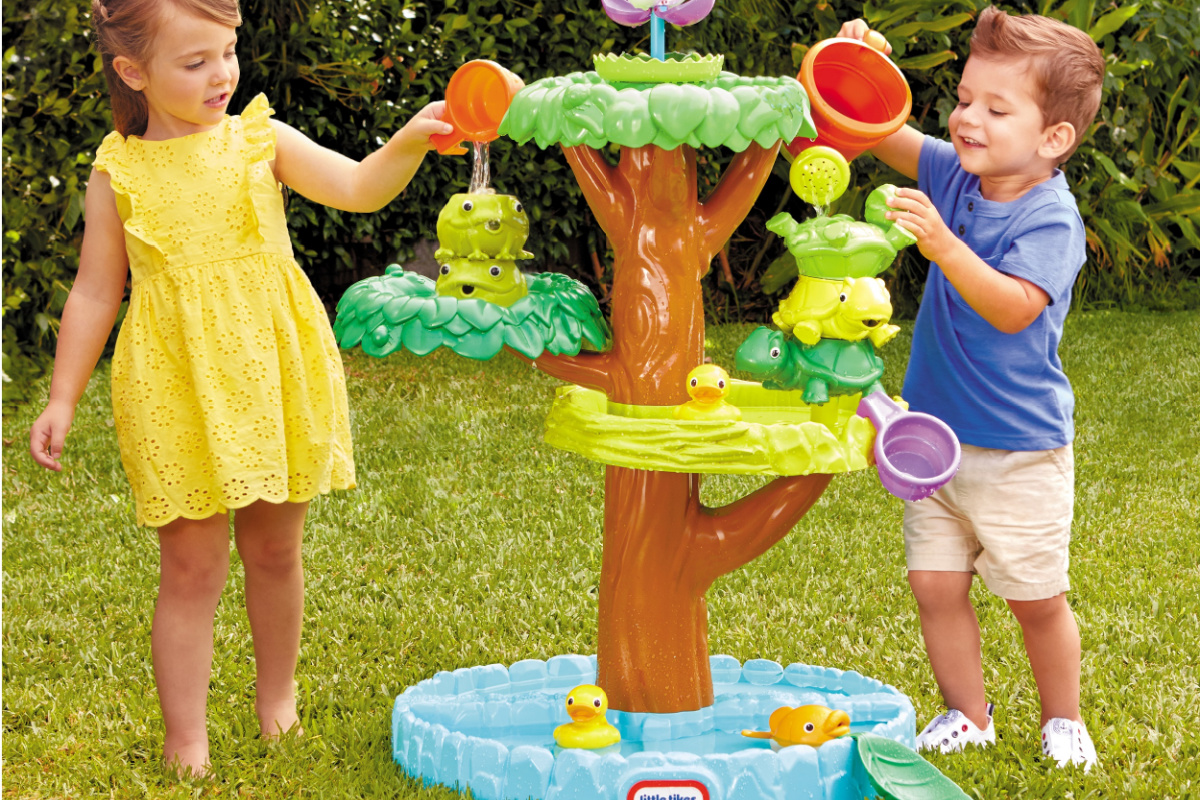 two children playing with little tikes water table
