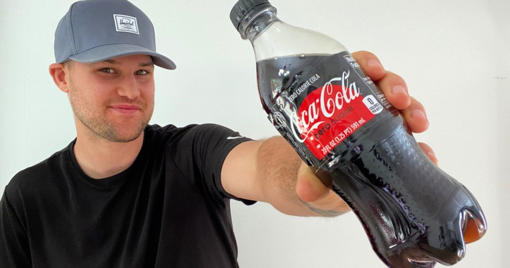 man holding coke bottle