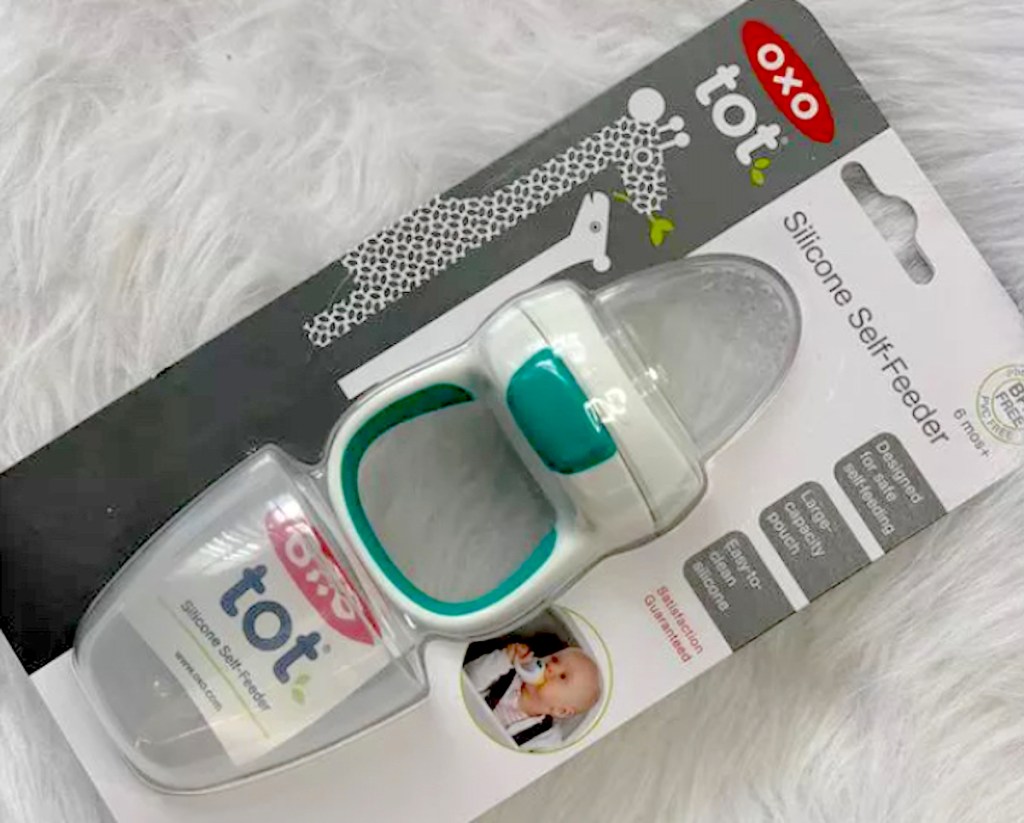 oxo silicone feeder in packaging on white fur blanket baby shower gift ideas