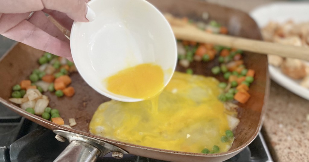 pouring egg in the pan for chicken fried rice