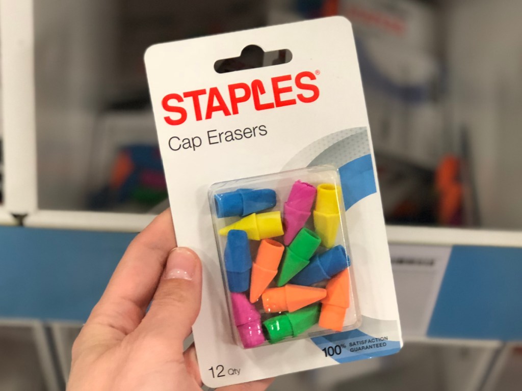 hand holding pack of colored erasers