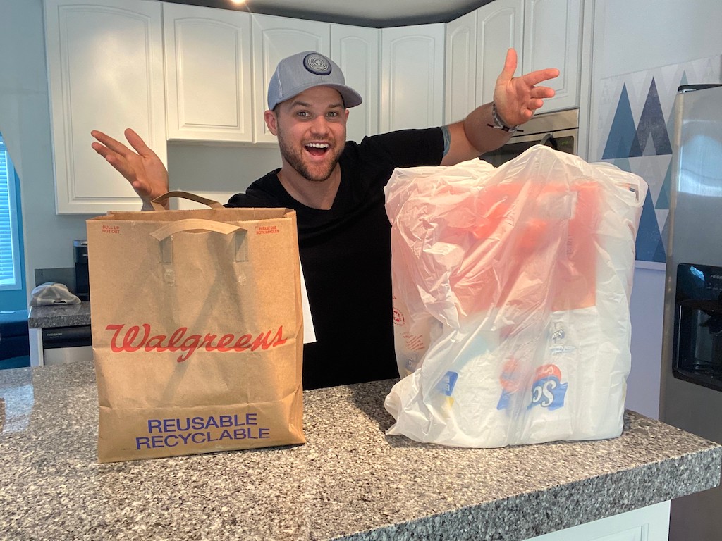 man with Walgreens bags in kitchen