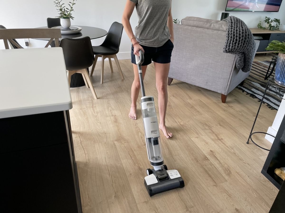 woman pushing tineco mop on wood floor