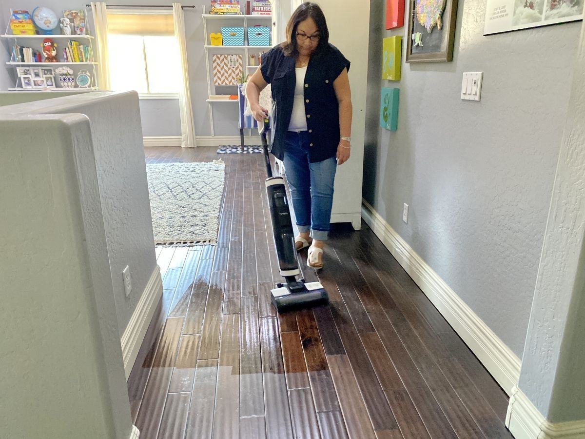 woman vacuuming hardwood floor