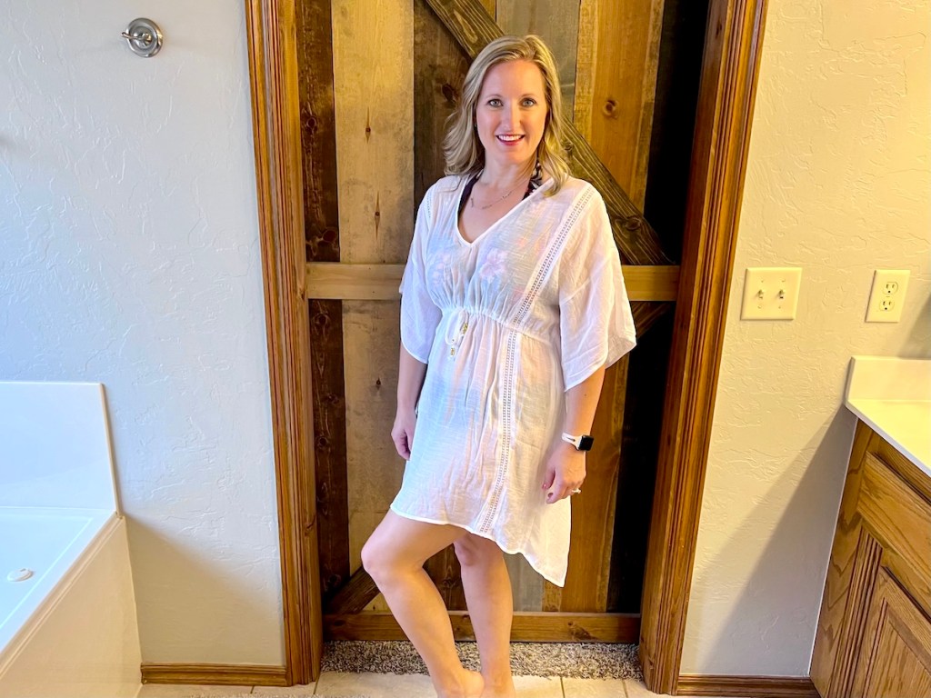 woman modeling white swimsuit cover ups in bathroom