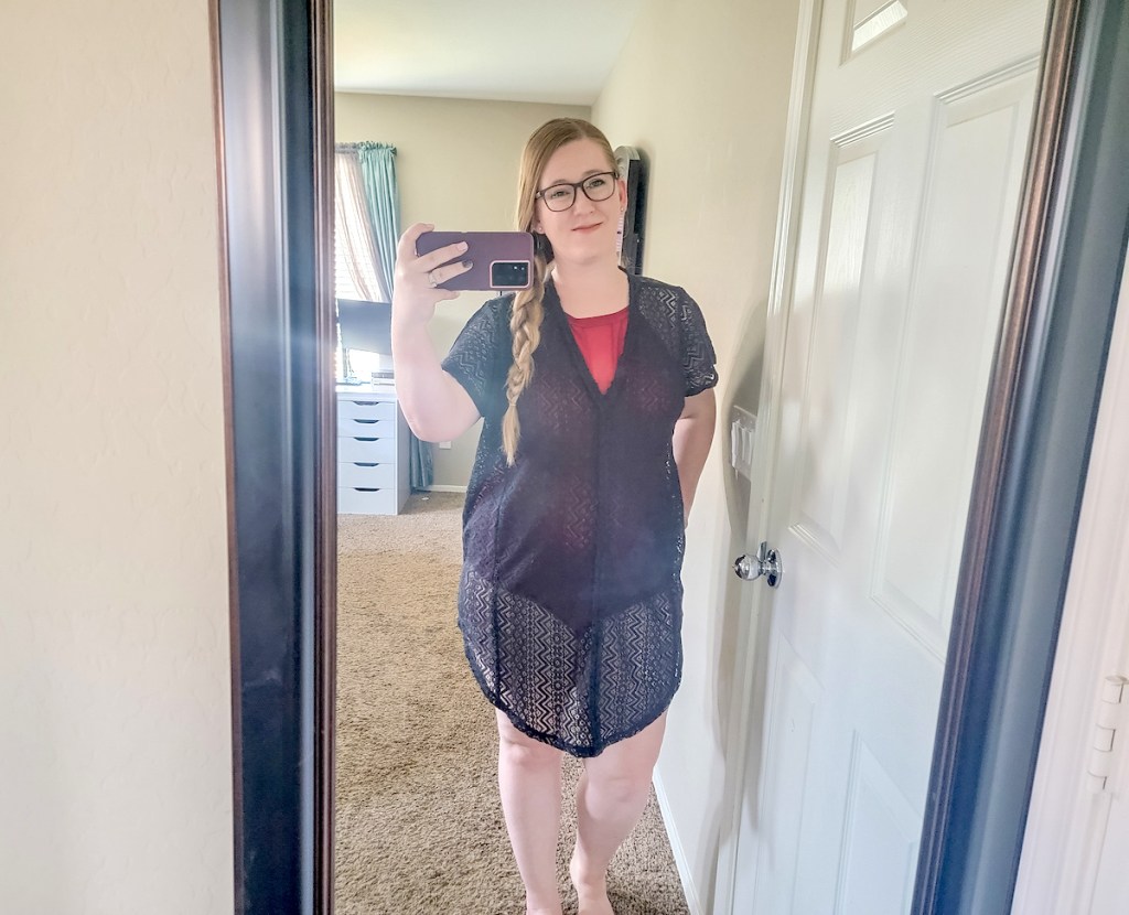 woman taking selfie in mirror wearing black crochet swimsuit cover ups