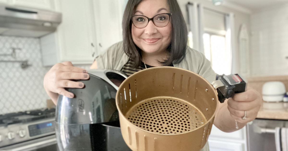 woman holding a replacement air fryer basket