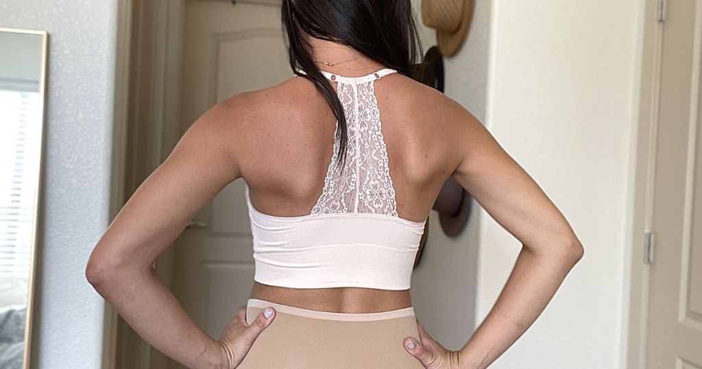 back view of woman wearing white lace bra