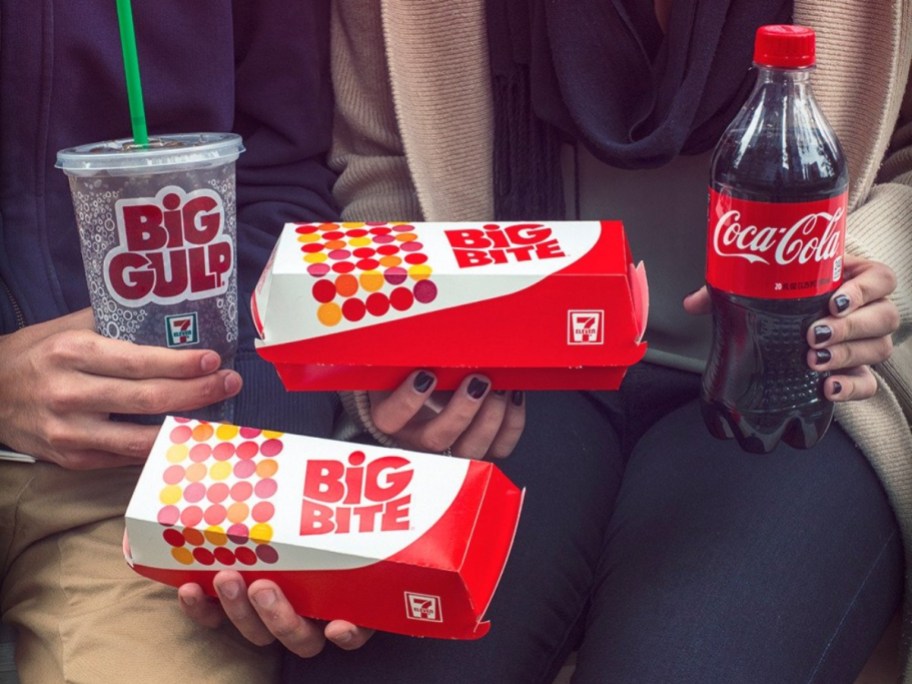 holding 2 Big Bites from 7 Eleven