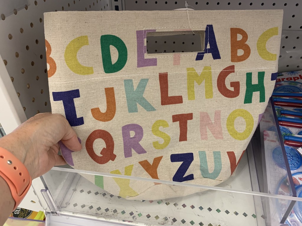 Hand holding up an Alphabet Tote
