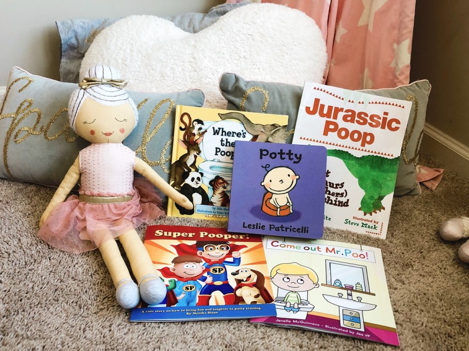 kids potty training books and doll on floor in child's bedroom