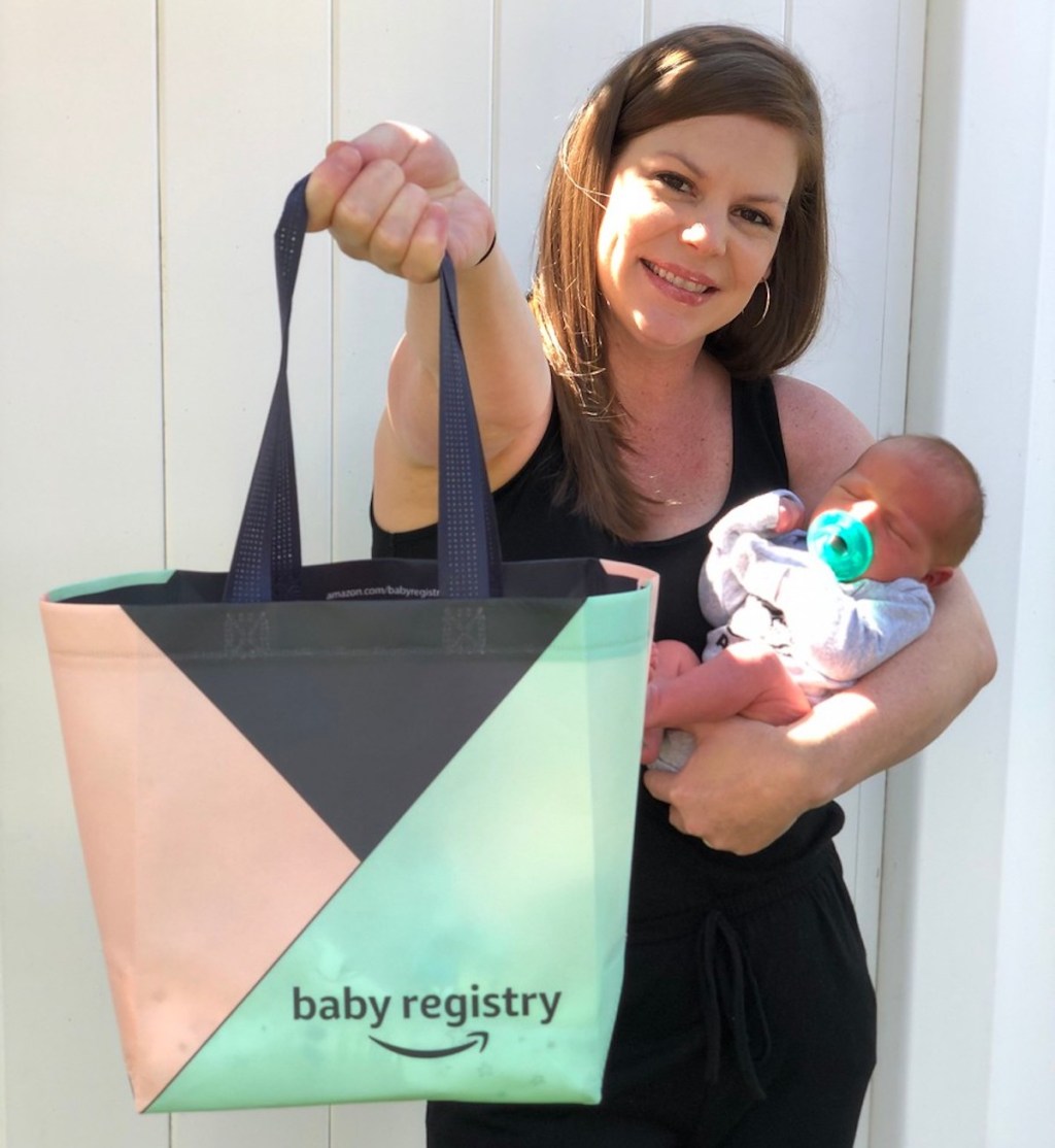 woman holding amazon baby registry bag and newborn 
