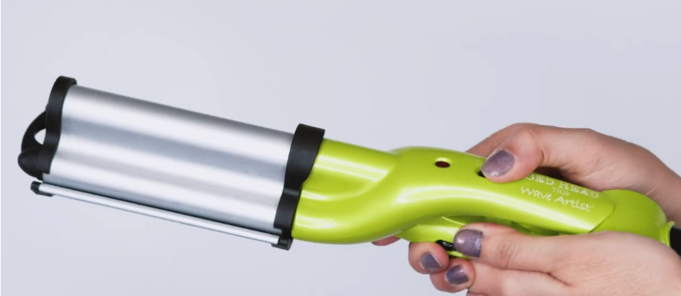 hand holding a Bed Head styling tool