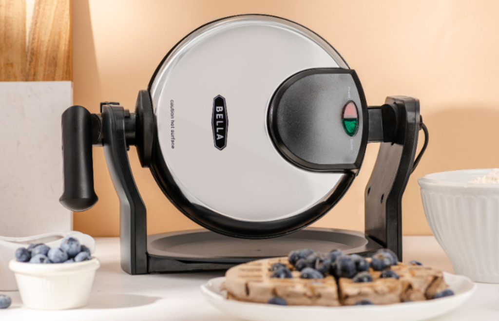 rotating waffle maker next to a plate of waffles